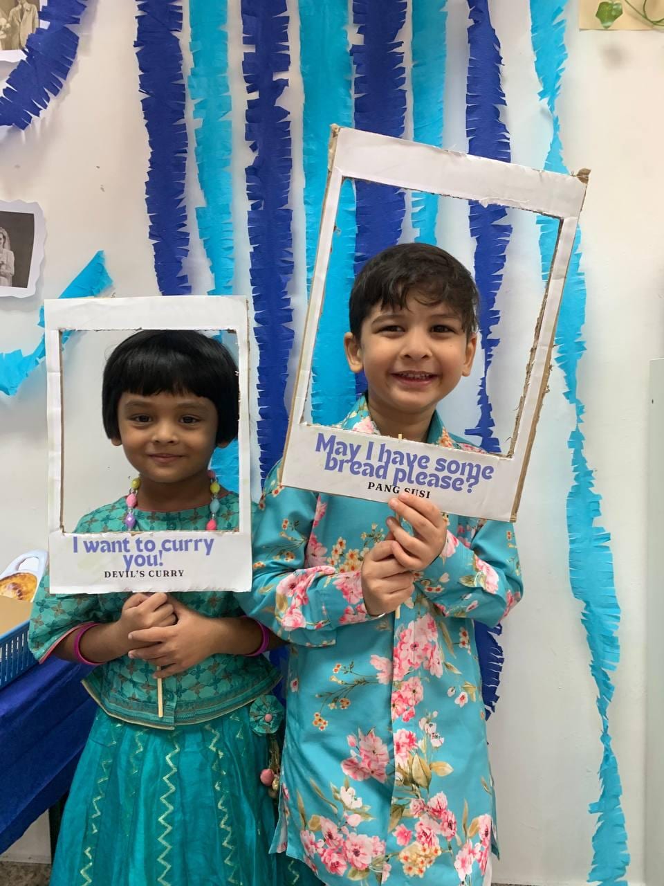 Child holding a framed photo at a special event