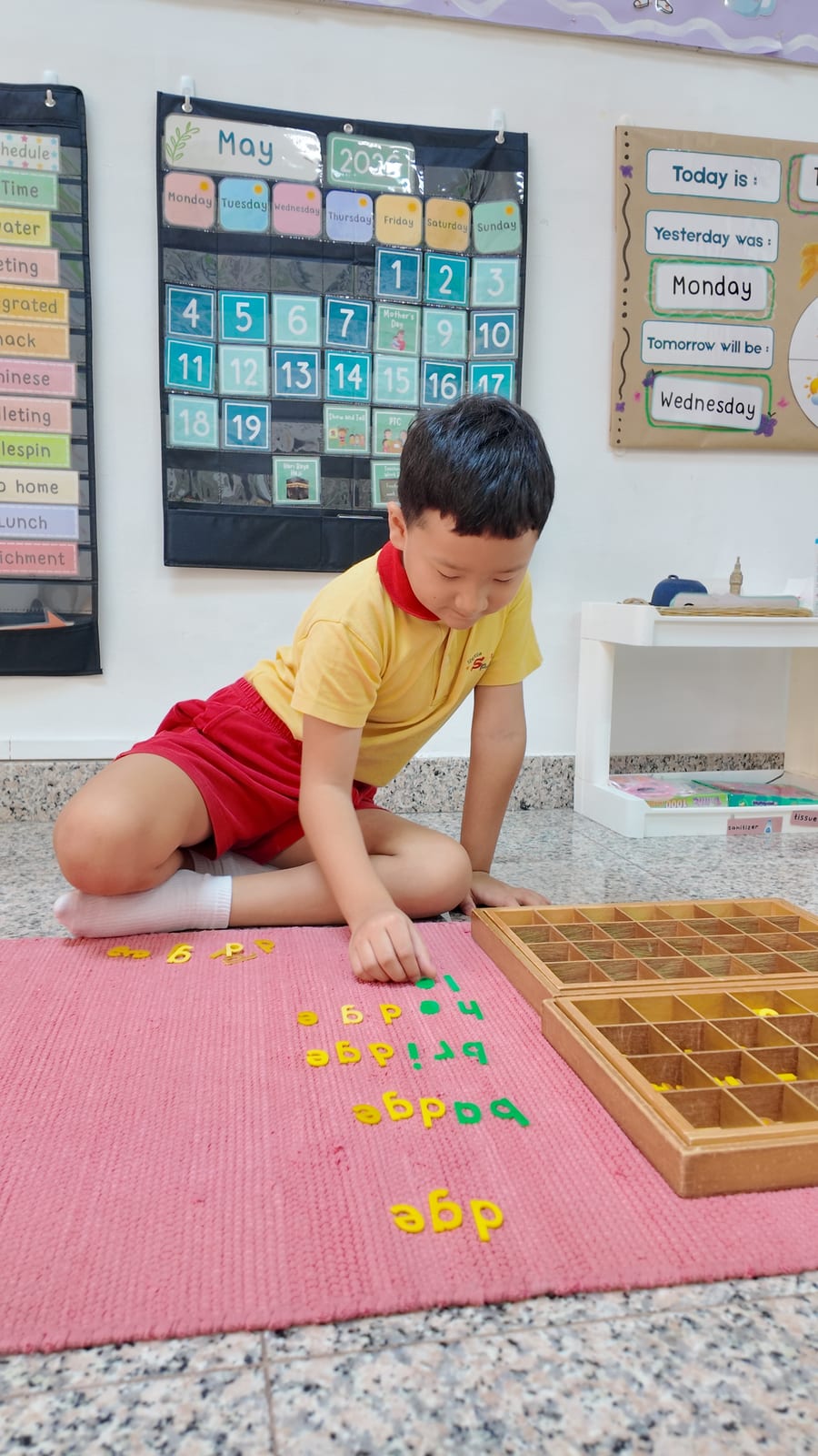 A child building words with the Montessori movable alphabet